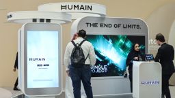 Guests stand at the booth of Saudi artificial intelligence company Humain.
