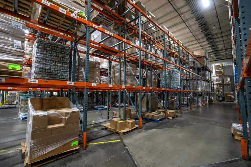 Partially empty shelves line the Harvesters food bank warehouse in Kansas City, on October 28, 2025.