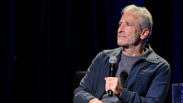 Jon Stewart, seen above at the 2025 New Yorker Festival last month, will continue hosting Mondays on “The Daily Show” through the end of 2026, Paramount announced.