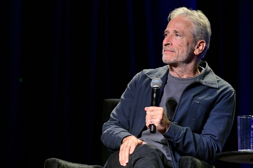 Jon Stewart, seen above at the 2025 New Yorker Festival last month, will continue hosting Mondays on “The Daily Show” through the end of 2026, Paramount announced.