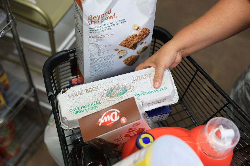 Groceries are placed in a cart at the Feeding South Florida food pantry on Mondy in Pembroke Park, Florida, as the pantry prepares for a possible surge in demand with SNAP benefits for some potentially ending due to the government shutdown.