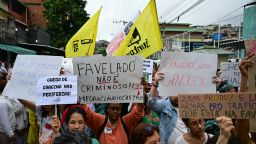 Activists and residents take part in a protest at the Penha Complex in Rio de Janeiro, Brazil, on October 31, 2025, to demand justice for victims of a massive police raid that left at least 117 suspected criminals and four police officers dead. (Photo by Pablo PORCIUNCULA / AFP) (Photo by PABLO PORCIUNCULA/AFP via Getty Images)          