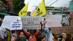 Activists and residents take part in a protest at the Penha Complex in Rio de Janeiro, Brazil, on October 31, 2025, to demand justice for victims of a massive police raid that left at least 117 suspected criminals and four police officers dead. (Photo by Pablo PORCIUNCULA / AFP) (Photo by PABLO PORCIUNCULA/AFP via Getty Images)
