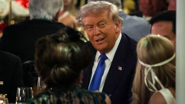 President Donald Trump talks with guests during a Halloween party at his Mar-a-Lago estate in Palm Beach, Florida on October 31, 2025.