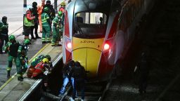 TOPSHOT - Police officers and members of the Emergency services search the track beneath an LNER Azuma train at Huntingdon Station in Huntingdon, eastern England, on November 1, 2025, following a stabbing on a train. UK police said they had arrested two suspects Saturday as "a number of people" were taken to hospital after a stabbing on a train in Cambridgeshire, eastern England. "We are currently responding to an incident on a train to Huntingdon where multiple people have been stabbed," British Transport Police said on X, adding that "two people have been arrested". (Photo by JUSTIN TALLIS / AFP) (Photo by JUSTIN TALLIS/AFP via Getty Images)          