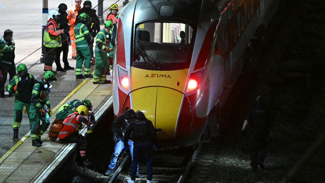 TOPSHOT - Police officers and members of the Emergency services search the track beneath an LNER Azuma train at Huntingdon Station in Huntingdon, eastern England, on November 1, 2025, following a stabbing on a train. UK police said they had arrested two suspects Saturday as "a number of people" were taken to hospital after a stabbing on a train in Cambridgeshire, eastern England. "We are currently responding to an incident on a train to Huntingdon where multiple people have been stabbed," British Transport Police said on X, adding that "two people have been arrested". (Photo by JUSTIN TALLIS / AFP) (Photo by JUSTIN TALLIS/AFP via Getty Images)          