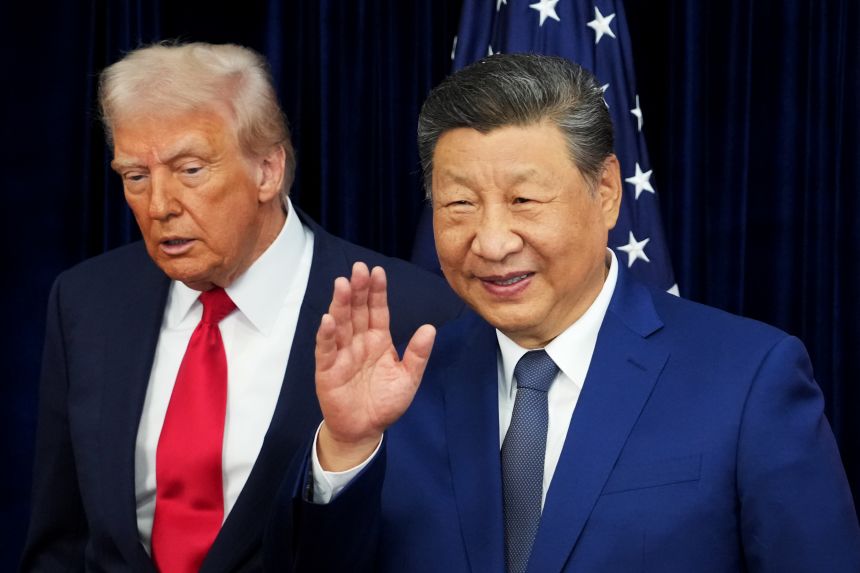 US President Donald Trump and Chinese President Xi Jinping react after posing for photos ahead of a bilateral meeting at Gimhae Air Base on October 30, 2025 in Busan, South Korea.