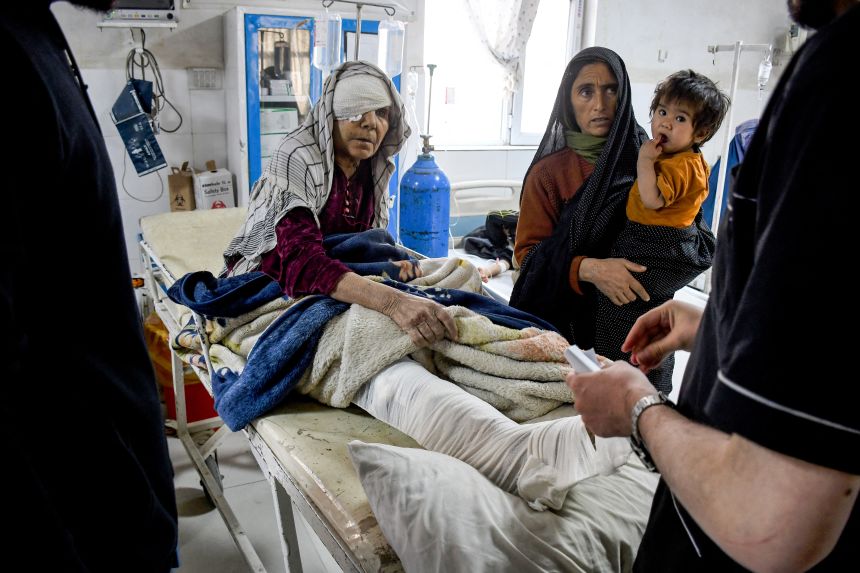 An injured woman receives hospital treatment following the earthquake.