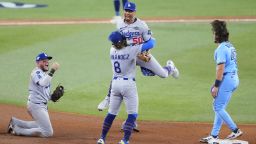 Miguel Rojas, Enrique Hernández and Mookie Betts of the Los Angeles Dodgers celebrate after defeating the Toronto Blue Jays 3-1 in Game 6.