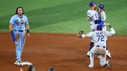 TORONTO, ONTARIO - OCTOBER 31: Miguel Rojas #72, Enrique Hernández #8, and Mookie Betts #50 of the Los Angeles Dodgers celebrate after defeating the Toronto Blue Jays 3-1 as Addison Barger #47 looks on in game six of the 2025 World Series at Rogers Center on October 31, 2025 in Toronto, Ontario.  (Photo by Vaughn Ridley/Getty Images)