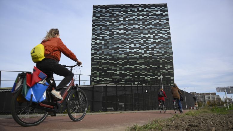 A woman rides past Nexperia headquarters in Nijmegen on November 6, 2025. (Photo by JOHN THYS / AFP) (Photo by JOHN THYS/AFP via Getty Images)