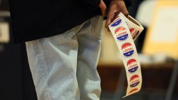 NEW YORK, NEW YORK - NOVEMBER 04: A poll worker holds "I Voted" stickers as people vote in the General Election at the P.S. 249 the Caton School on November 04, 2025 in the Flatbush neighborhood of the Brooklyn borough in New York City. Voters in NYC are voting for who will be replacing Mayor Eric Adams between the front runner New York Mayoral Candidate Zohran Mamdani and New York City mayoral candidate Andrew Cuomo and Republican mayoral candidate Curtis Sliwa. More than 735,000 people have voted early, according to the Board of Elections, more than four times as many as in the 2021 contest. This election also has other city offices on the ballot, as well as six proposals  (Photo by Michael M. Santiago/Getty Images)