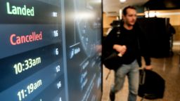 A cancelled flight on a departures board at Seattle-Tacoma International Airport (SEA) in Seattle, Washington on Friday.