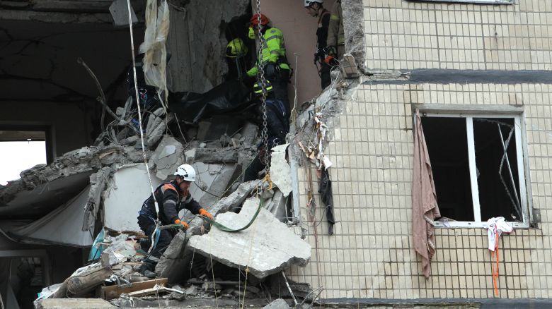 Rescuers work at an apartment block hit by a Russian drone in Dnipro, Ukraine, on November 8, 2025. A total of three people are killed and 12 people are injured, including two children, as a result of the nighttime Russian attack on the city. The Russian strike destroys apartments on the 4th to 6th floors.