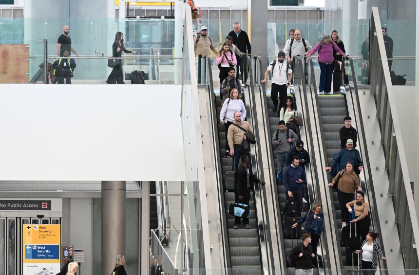Travelers make their way through Denver International Airport on Thursday.