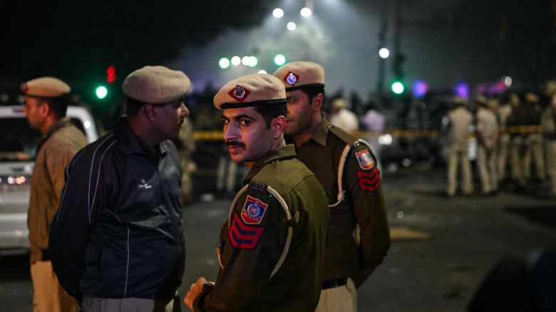Police personnel gather at the blast site after an explosion near the Red Fort in the old quarters of Delhi on November 10, 2025.