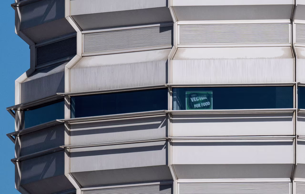A sign which says "Will Vector for Food" is displayed from a window in the control tower at Ronald Reagan Washington National Airport on Monday.