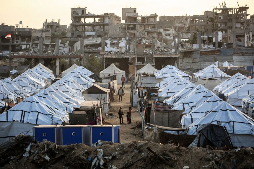 Palestinian youth play at a displacement camp in Nuseyrat, Gaza Strip, on November 11.