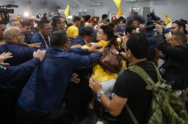 Security personnel clash with indigenous people and students who storm the COP30 venue in Belem, Para state, Brazil, November 11, 2025.