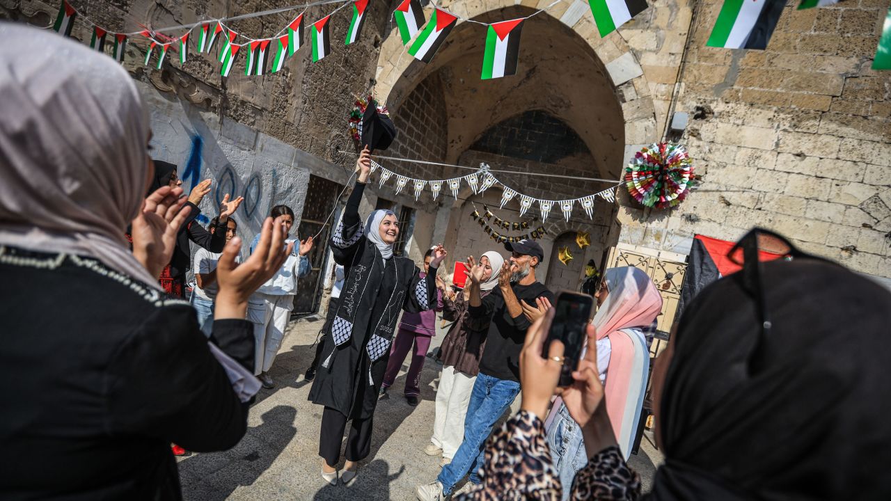 GAZA CITY, GAZA - NOVEMBER 13: Palestinian student Iman Lulu celebrates with her family in Gaza City, Gaza after passing the high school final exams, which were held for the first time in two years despite the ongoing Israeli attacks that destroyed schools and displaced thousands of families across the Gaza, on November 13, 2025. (Photo by Hamza Z. H. Qraiqea/Anadolu via Getty Images)