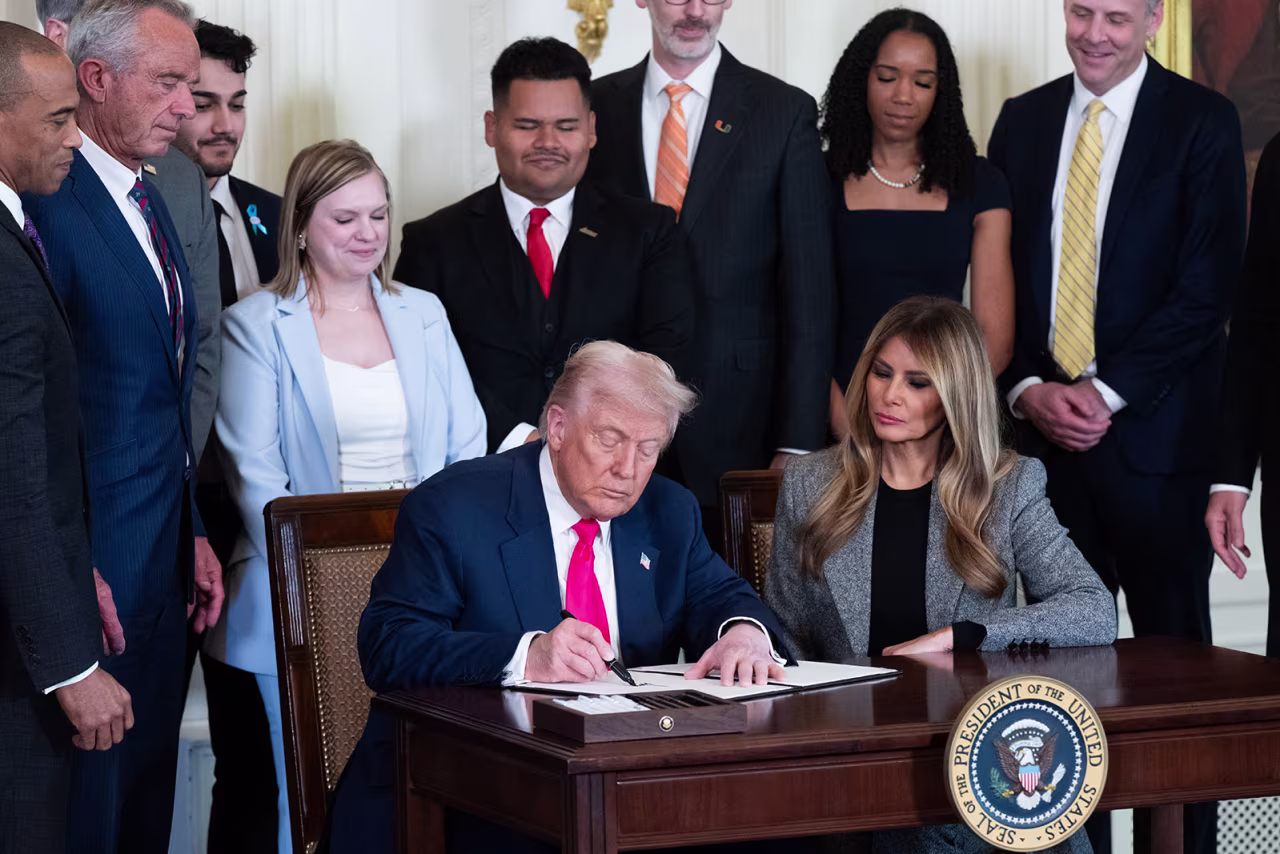 President Donald Trump, alongside the First Lady Melania Trump, signs an executive order to strengthen the foster care system, as part of the First Lady's "Fostering the Future" initiative in the East Room of the White House in Washington, DC on Thursday.