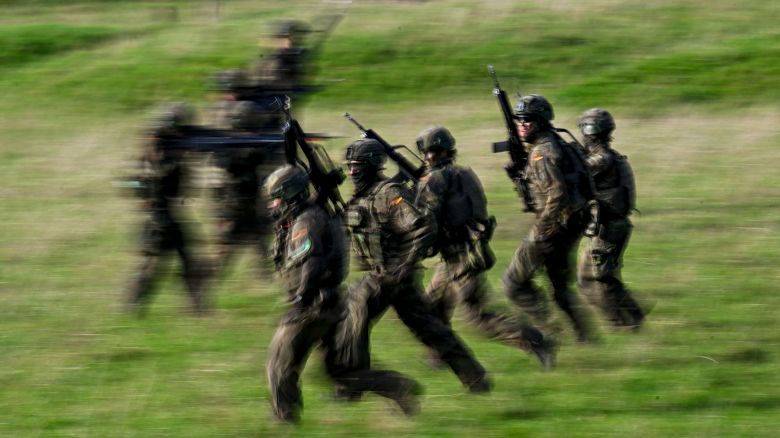 Recruits attend a combat exercise with the G36 assault rifle at the Westfalen-Kaserne barracks of the German armed forces (Bundeswehr) in Ahlen, western Germany, during a media day about the basic training for Bundeswehr recuits, on November 13, 2025. Germany's coalition government has agreed a new voluntary military service model, politicians said on November 13, 2025, after weeks of wrangling over whether there should be a compulsory element. From the year 2026, all 18-year-old men will have to fill in a questionnaire on whether they would want to serve and undergo an armed forces physical test, if the plan is adopted.