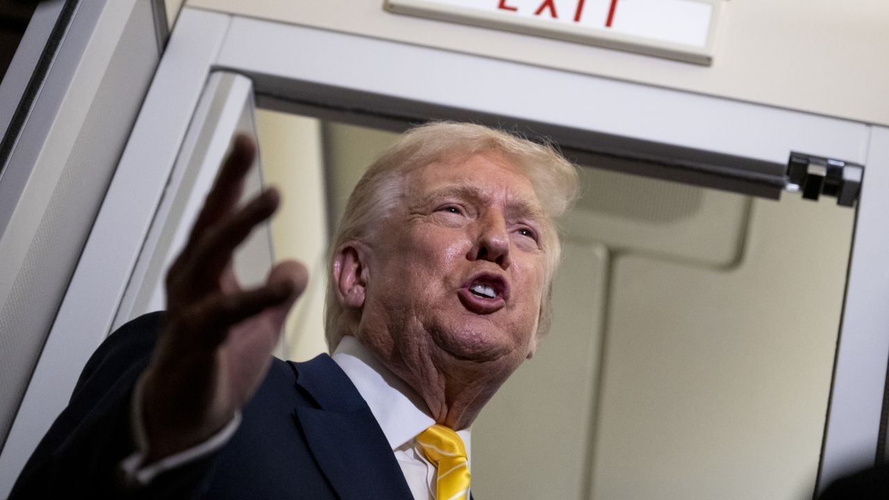 President Donald Trump speaks to reporters aboard Air Force One on November 14, 2025.