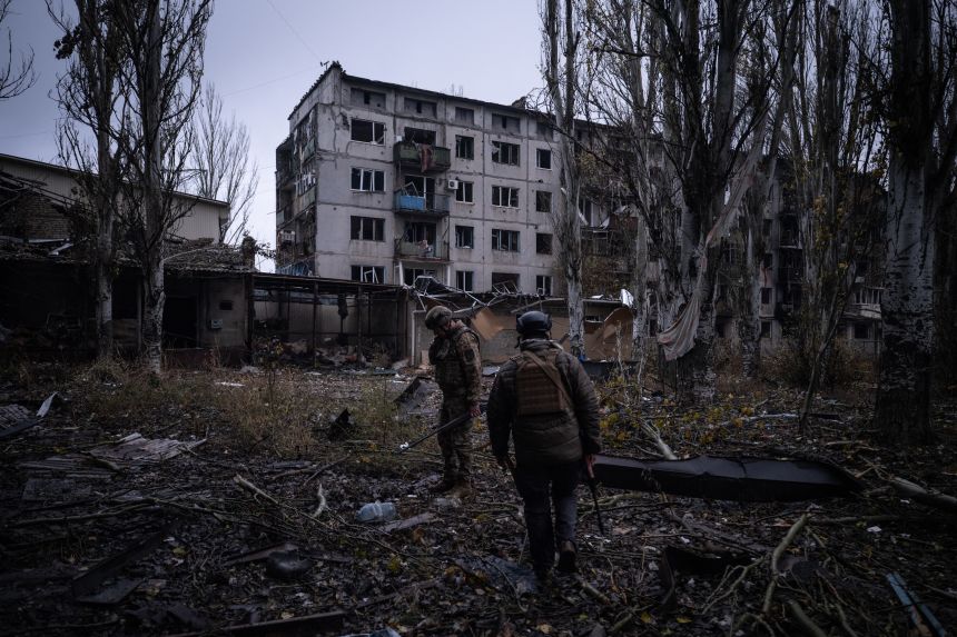 Ukrainian servicemen next to a destroyed buildings in the frontline town of Kostyantynivka, Donetsk region.