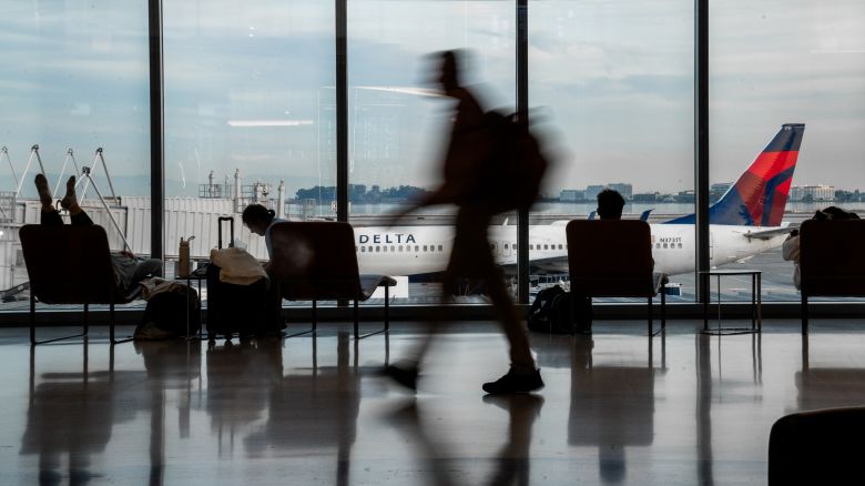 Passengers walk at the hall of San Francisco International Airport in San Francisco, California on November 10, 2025.