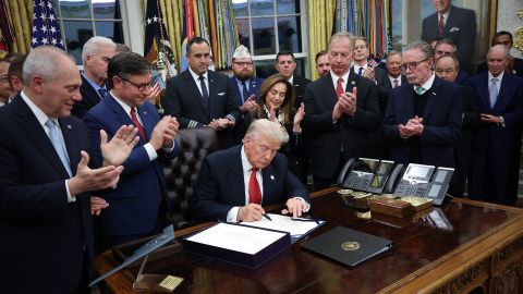 President Donald Trump signs funding legislation to reopen the federal government alongside Republican lawmakers and business leaders, November 12, 2025, in Washington, DC.