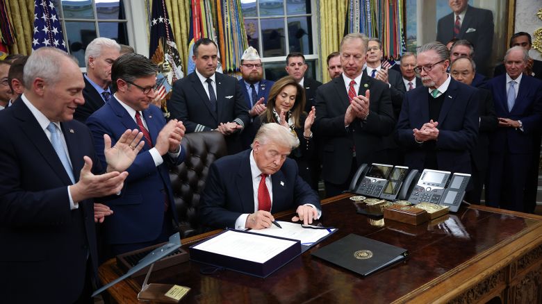 President Donald Trump signs funding legislation to reopen the federal government alongside Republican lawmakers and business leaders, November 12, 2025, in Washington, DC.