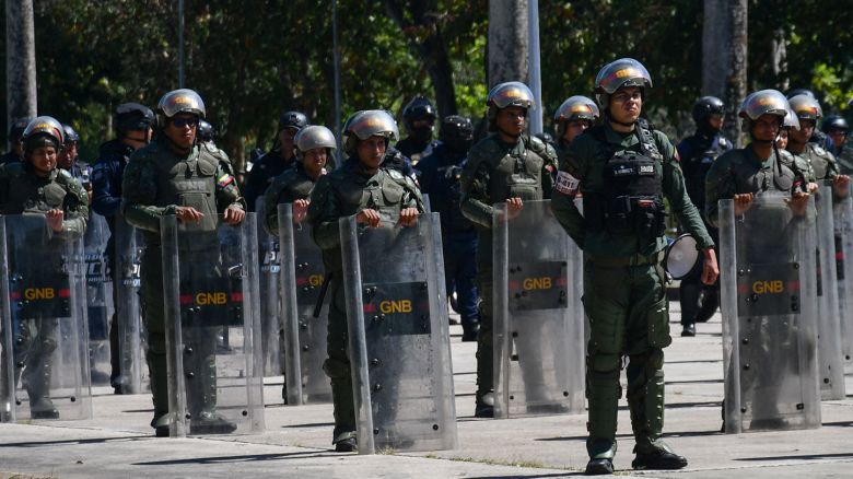 Members of the Bolivarian National Guard attend the launch of "Plan Republica," a security operation for the fourth popular consultation scheduled for November 23, at Campo Carabobo in Valencia, Venezuela, on November 19, 2025. (Photo by Jacinto OLIVEROS / AFP) (Photo by JACINTO OLIVEROS/AFP via Getty Images)          
