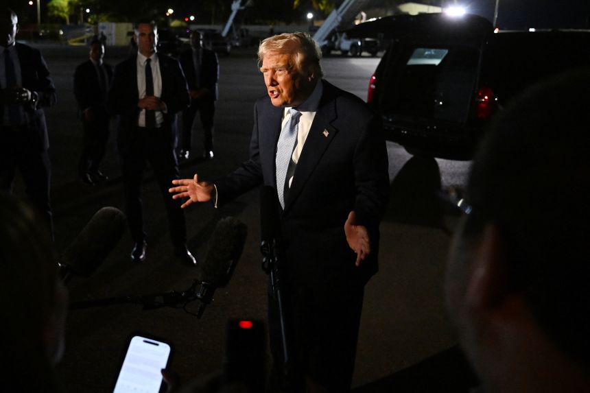 President Donald Trump speaks to reporters before boarding Air Force One at Palm Beach International Airport in West Palm Beach, Florida, on November 16.