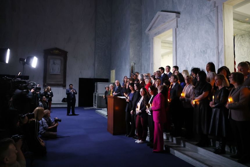 Attendees take part in a vigil hosted for survivors of convicted sex abuser Jeffrey Epstein by the Democratic Women's Caucus in Washington, DC, on November 18, 2025.