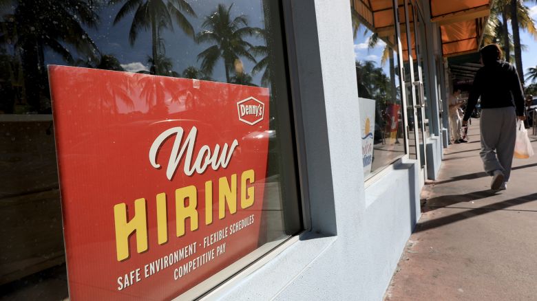 A 'Now Hiring' sign sits in the window of a Denny's restaurant on November 19 in Miami.