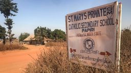 A signboard for St Mary's Private Catholic Secondary School stands at the entrance of the school in Papiri, Agwarra local government, Niger state, on November 23, 2025. Fifty of the more than 300 children snatched by gunmen from a Catholic school in Nigeria have escaped their captors, a Christian group said in a statement on November 23. "We have received some good news as fifty pupils escaped and have reunited with their parents," said the Christian Association of Nigeria in a statement, adding they escaped between November 21 and 22. Gunmen raided early November 21 St Mary's co-education school in Niger state in western Nigeria, taking 303 children and 12 teachers in one of the largest mass kidnappings in Nigeria.