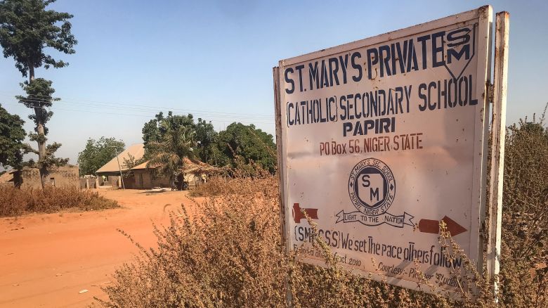 A signboard for St Mary's Private Catholic Secondary School stands at the entrance of the school in Papiri, Agwarra local government, Niger state, on November 23, 2025. Fifty of the more than 300 children snatched by gunmen from a Catholic school in Nigeria have escaped their captors, a Christian group said in a statement on November 23. "We have received some good news as fifty pupils escaped and have reunited with their parents," said the Christian Association of Nigeria in a statement, adding they escaped between November 21 and 22. Gunmen raided early November 21 St Mary's co-education school in Niger state in western Nigeria, taking 303 children and 12 teachers in one of the largest mass kidnappings in Nigeria.