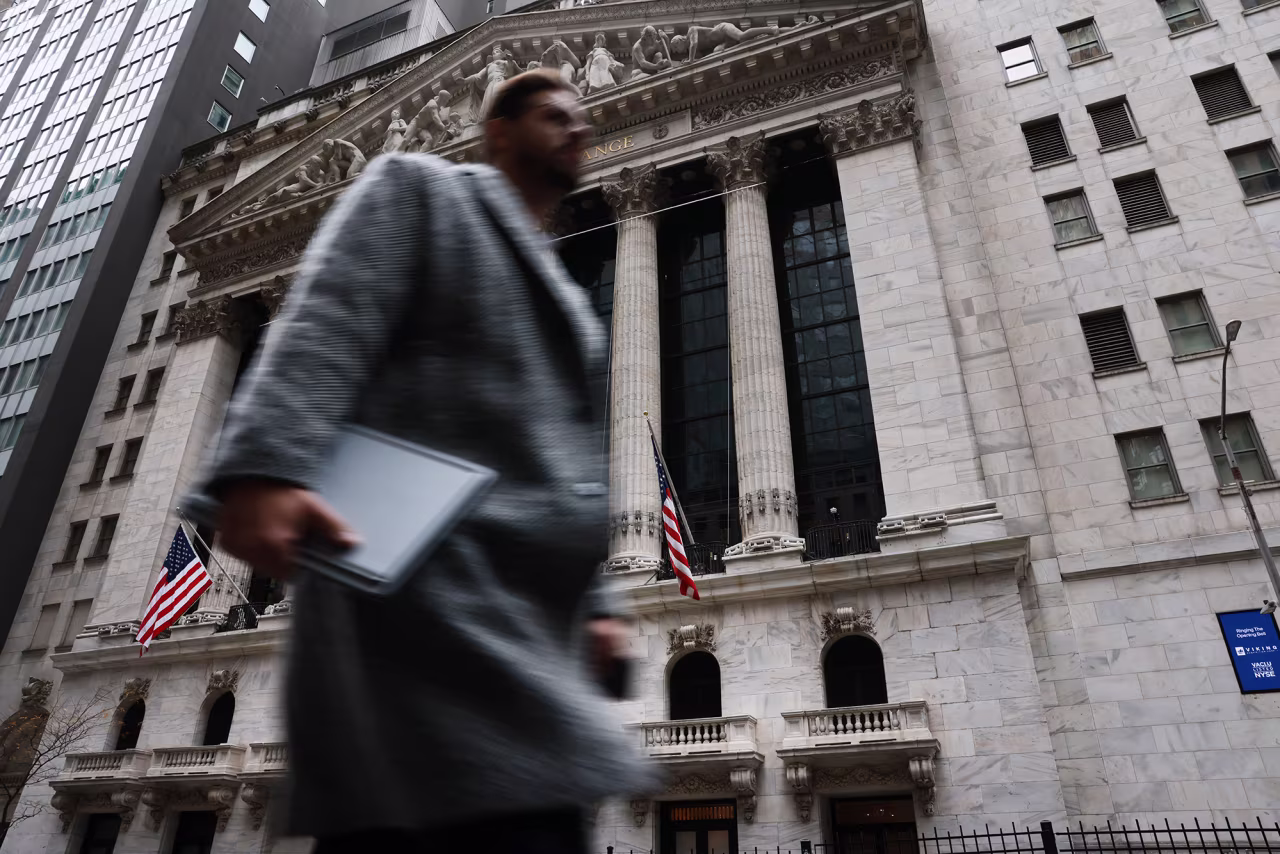 People walk past the New York Stock Exchange on Thursday.