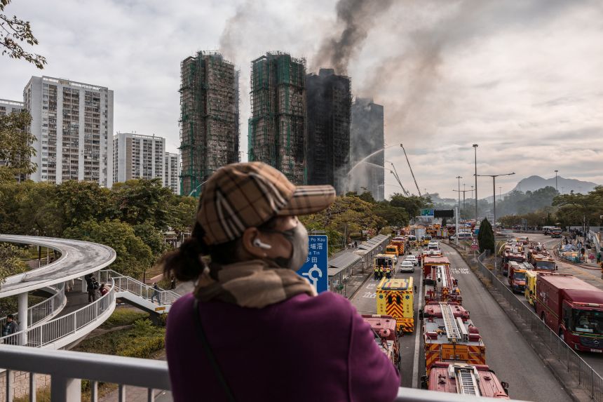 Smoke rises from apartments after a major fire swept through several blocks at the Wang Fuk Court residential estate in Tai Po, Hong Kong, on November 27, 2025.