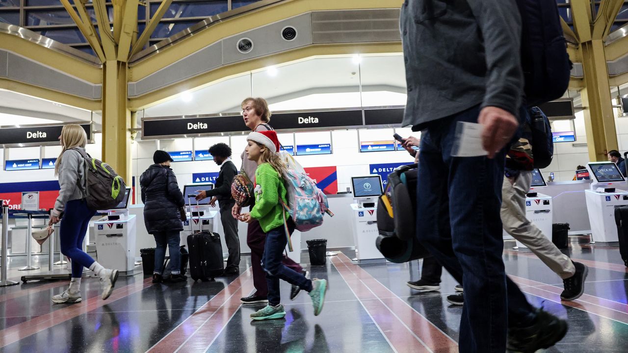 ARLINGTON, VIRGINIA - NOVEMBER 25: Travelers walk through the Ronald Reagan Washington National Airport on November 25, 2025 in Arlington, Virginia. Airlines expect up to 31 million travelers will fly during Thanksgiving holiday between November 21 through December 1. (Photo by Anna Moneymaker/Getty Images)