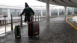 A traveler at O'Hare International Airport (ORD) during a snowstorm in Chicago, Illinois, US, on Saturday, Nov. 29, 2025. Hundreds of flights have been canceled in and around Chicago and roads are becoming treacherous as one of the busiest travel weekends of the year collides with a major storm bringing wintery conditions throughout the US Midwest Saturday.