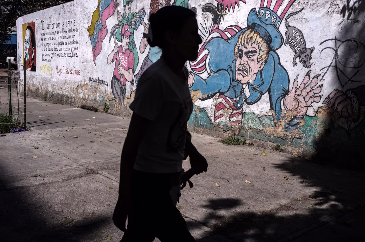 A person walks past anti-US graffiti in Caracas, Venezuela, on November 27.