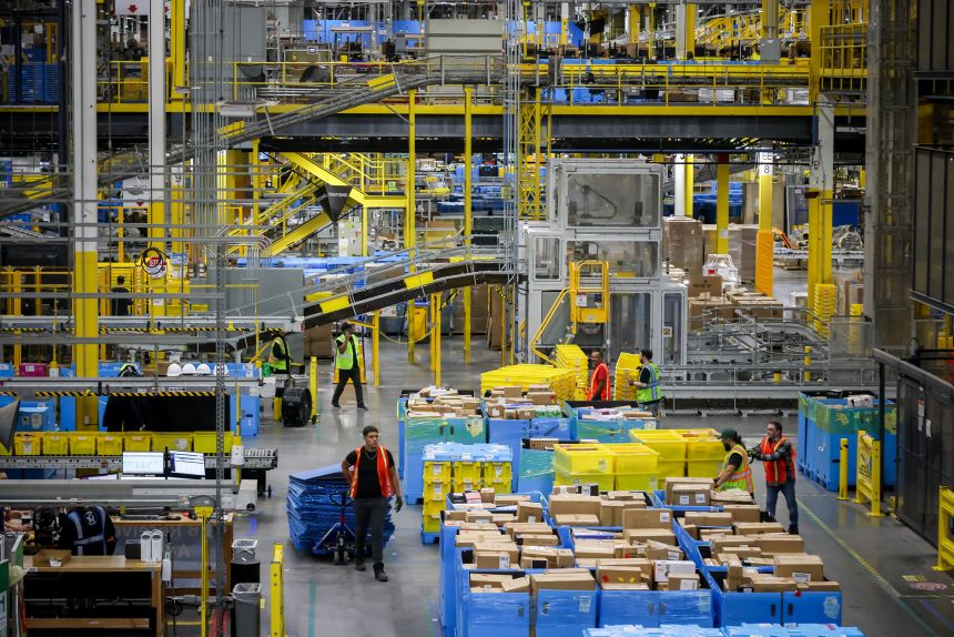 Workers at an Amazon Fulfillment center on Cyber Monday in Robbinsville, New Jersey, US, on Monday, Dec. 1, 2025. US consumers are heading into the official start of the holiday shopping season with a host of economic concerns, including a cooling job market, stagnant wages, persistent inflation and the looming fallout from tariffs.