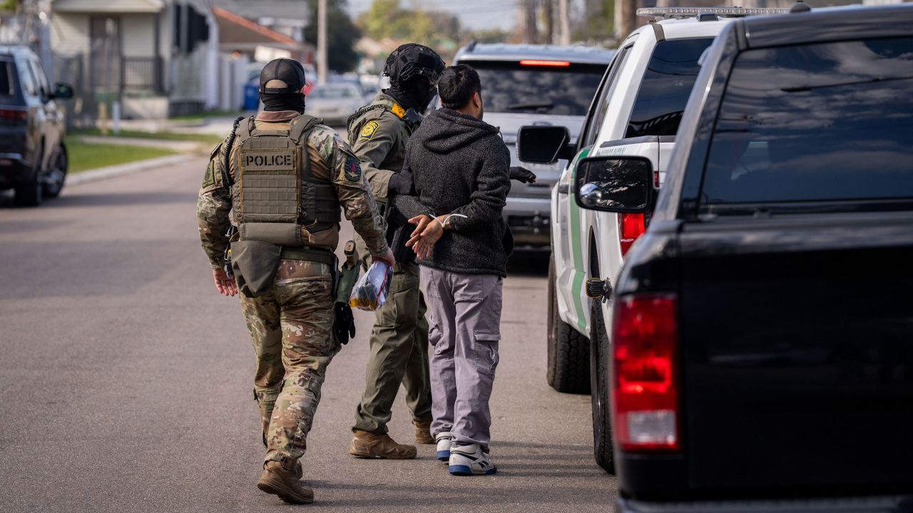 A person is detained by US Customs and Border Patrol (CBP) and other federal law enforcement agents in New Orleans, Louisiana, on December 3, 2025. The US Department of Homeland Security announced on Wednesday it has launched a federal immigration enforcement operation, named "Operation Catahoula Crunch," in the New Orleans, Louisiana, area. (Photo by Adam GRAY / AFP via Getty Images)