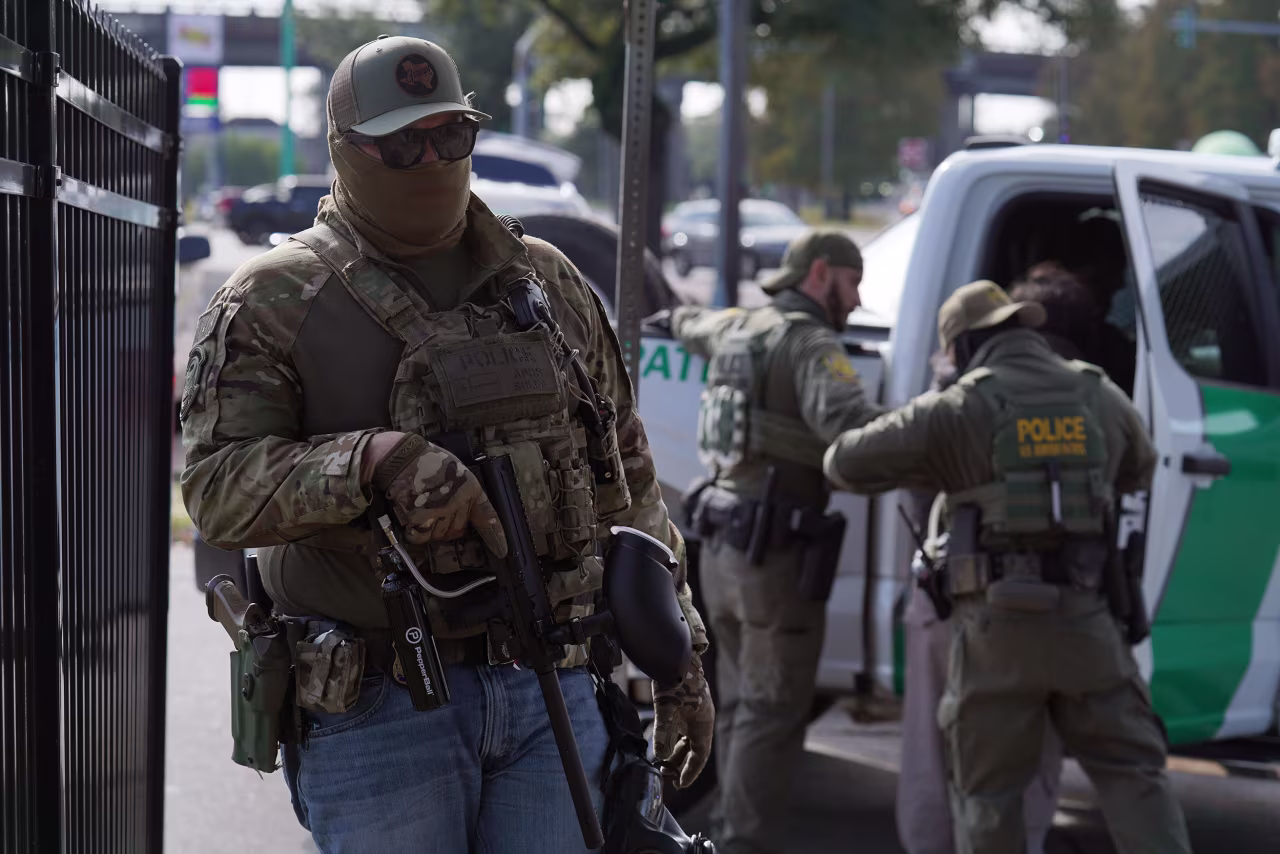 Border Patrol agents detain a man on the street on Wednesday in New Orleans.