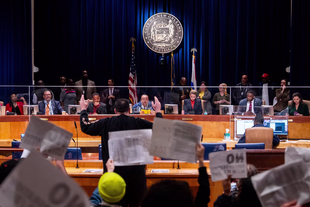 Protestors shout at city council members during a meeting at City Hall in New Orleans, Louisiana, on Thursday.
