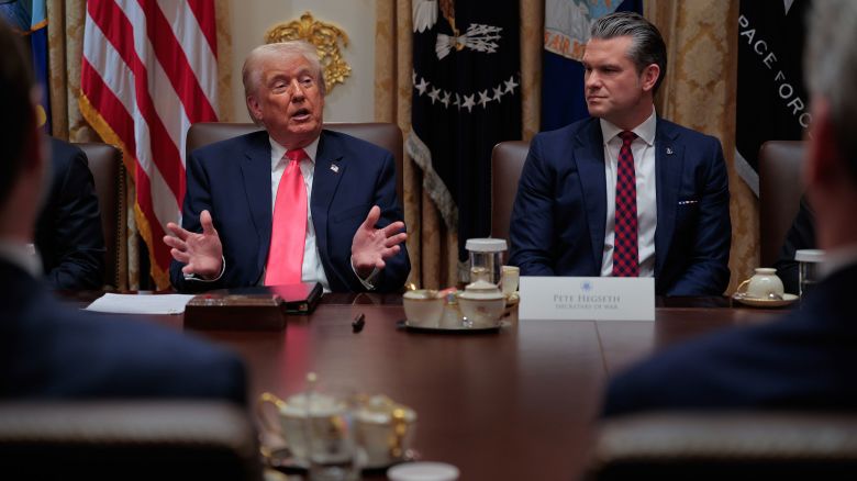 President Donald Trump speaks as Secretary of Defense Pete Hegseth looks on during a meeting in the Cabinet Room of the White House on Tuesday.