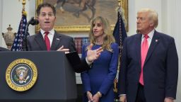 Michael Dell speaks as his wife Susan Dell and President Donald Trump look on while making an announcement about "Trump Accounts."