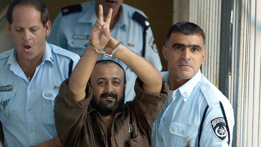 Palestinian leader Marwan Barghouti is taken away under escort on September 29, 2003 in Tel Aviv, Israel, after proceedings in his trial in the Tel Aviv District Court.