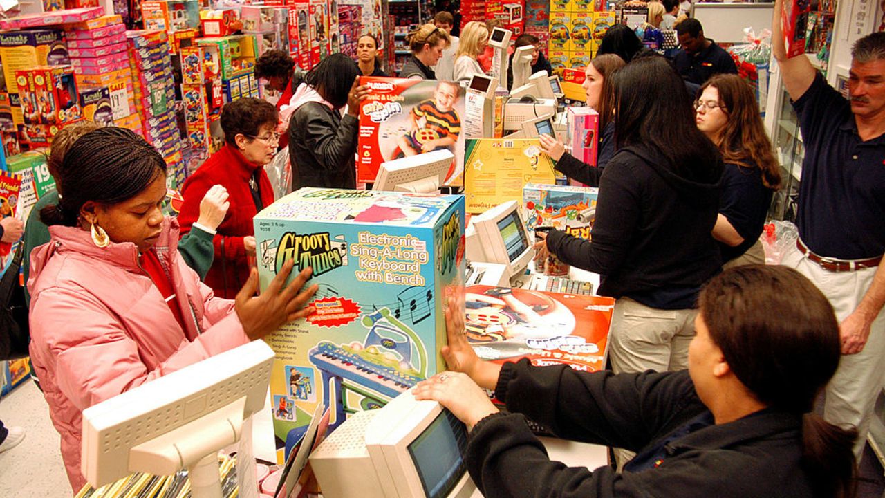 KING OF PRUSSIA, PA - NOVEMBER 28:  Customers pay for their items while doing their Black Friday shopping at KB Toys, which opened at 5am, in the King of Prussia Mall November 28, 2003 in King of Prussia, Pennsylvania.  Black Friday is traditionally when stores get out of the red and start making a profit for the year. Economists expect a 5 percent increase in holiday sales over last year.  (Photo by William Thomas Cain/Getty Images)